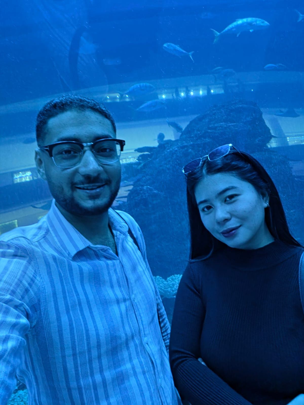 A selfie of Kim and me smiling in front of the big tank at Dubai Aquarium